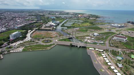 aerial view of the ocean and river in makassar city sulawesi indonesia during a sunny day with buildings in the distance