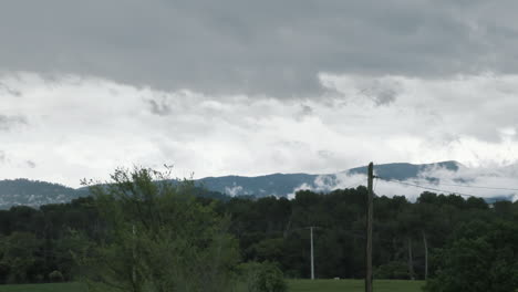 timelapse panning of the movement of clouds after a storm over a small town