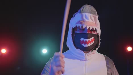 person in shark costume playing drums on stage