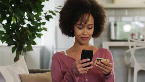 Woman-using-her-credit-card-to-buy-online