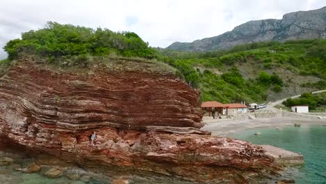 red rock coastline with person