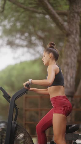 woman working out on an air bike outdoors