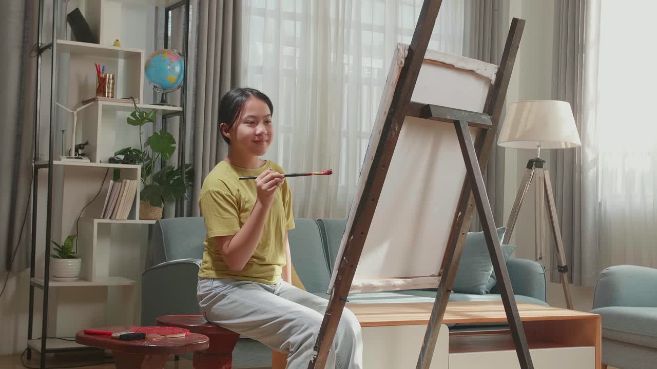 Asian Artist Girl Holding Paintbrush Mixed Colour And Thinking Before Painting On The Canvas