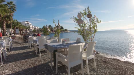 quiet cozy beachfront restaurant dining at bodrum promenade with shimmering aegean sea view