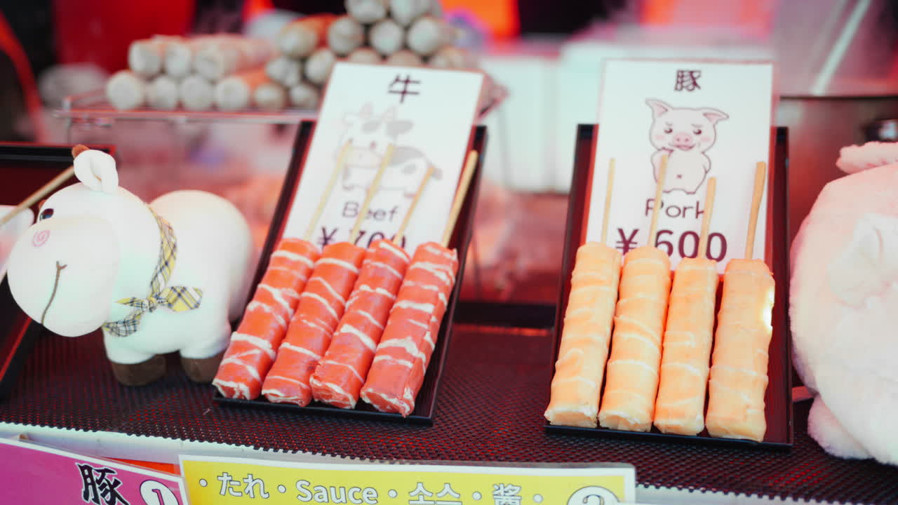 Close up of pork and beef skewers at a street food market in Japan