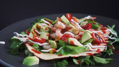 Freshly-Prepared-Flat-Open-Shrimp-Taco-rotating-on-black-background,-4k