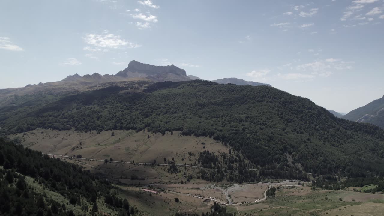 4K drone shot over the Western Valleys Natural Park in the Aragonese Pyrenees, Spain, filmed with a DJI at 30fps. A stunning aerial view of the prairie leading to Ibón de Acherito with mountain views.