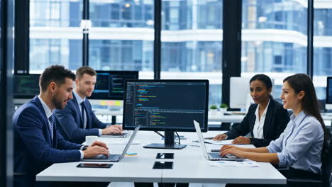 business professionals collaborating on code in a modern office setting