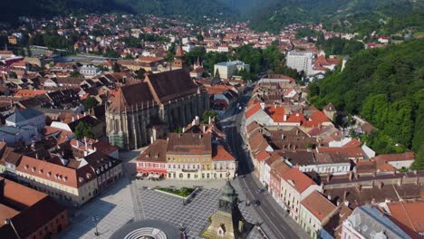 cinematic drone video of main square and scenic town of brasov in romania