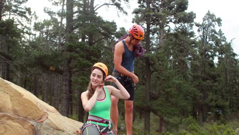 smiling couple preparing themselves to rock climb