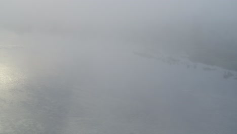 Bird-flying-over-the-Neris-river-in-Kaunas-county,-Lithuania