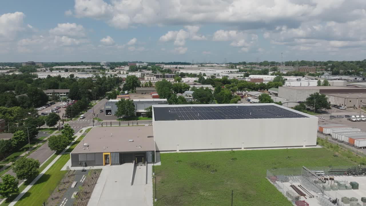 A Modern New Commercial Building With Rooftop Solar Panels. Aerial Drone Shot