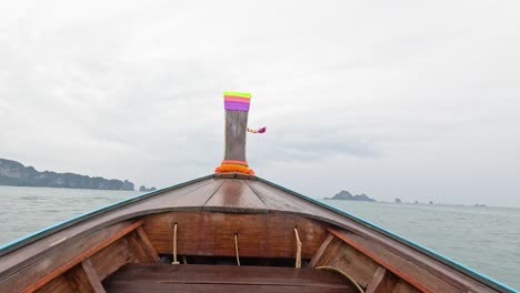 boat travels through ocean towards distant islands