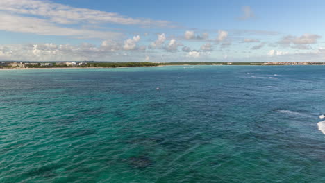 Aerial-timelapse-hyperlapse-of-turquoise-blue-ocean-water-waves,-cloud-movement-in-sky