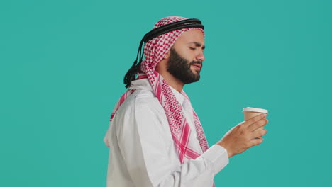 islamic person drinking cup of coffee