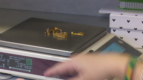 weighing gold jewelry on a scale