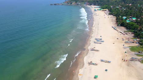 arambol goa beach drone shot ships boats on empty beach birds-eye view top view done up