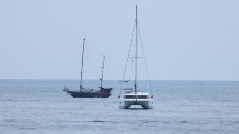 two yachts moving parallel in calm sea