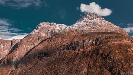 Magnificent-mountain-towering-above-still-waters-of-the-fjord