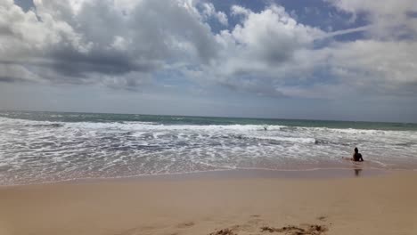 woman alone on the beach suntan covered in indian ocean waves, nature holiday trip relaxation