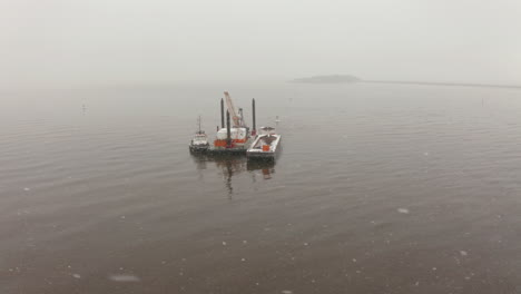 Aerial-view-of-a-vessel-in-the-Bay-of-Fundy-on-an-icy,-winter-day