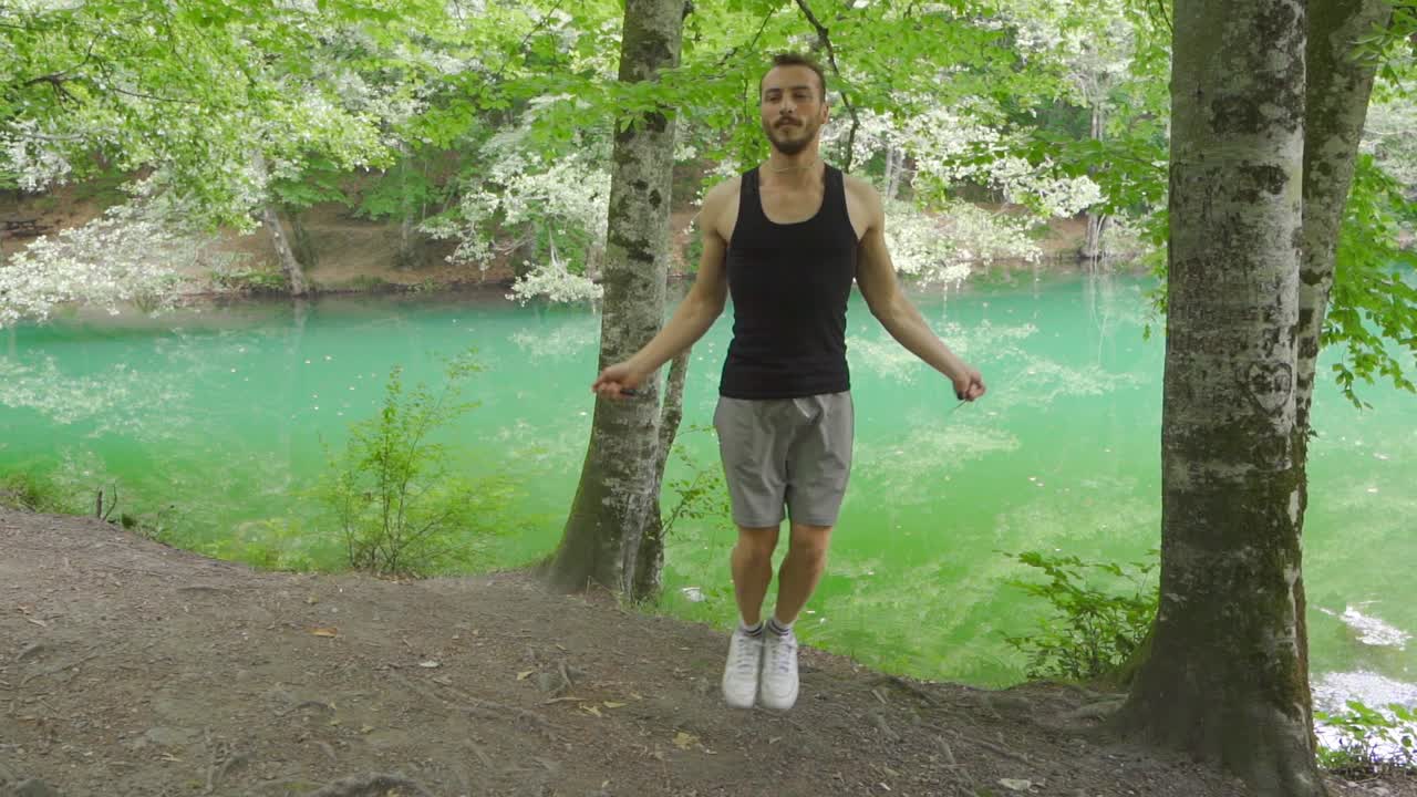 Man doing sports in nature. He's skipping.