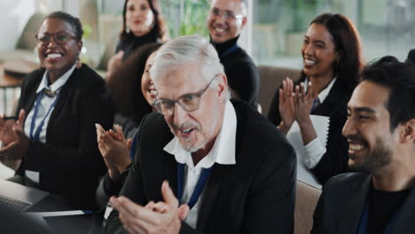 business people applaud a speaker at a conference