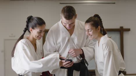 people using smartphone in a dojo