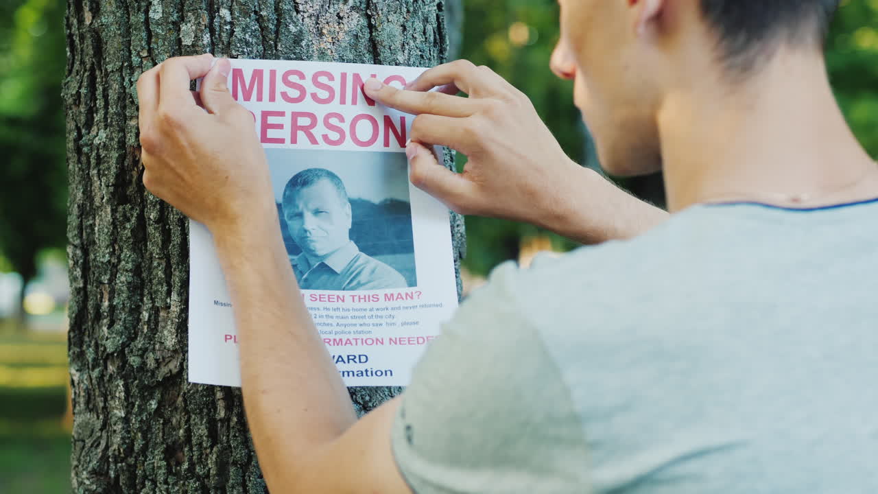 A Young Man Puts Up Ads For A Missing Person In The Park