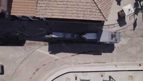 view of road workers and asphalt reconstruction, heavy machinery road works