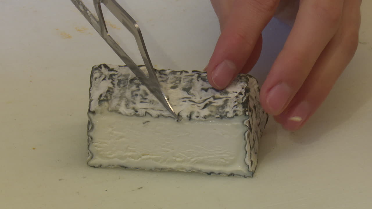 Cutting a piece of cheese