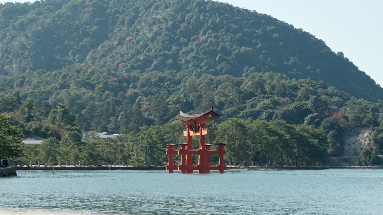 A breathtaking view of the Itsukushima Shrine torii gate on Miyajima Island, capturing the balance of history, spirituality, and the surrounding calm waters of Hiroshima, Japan.