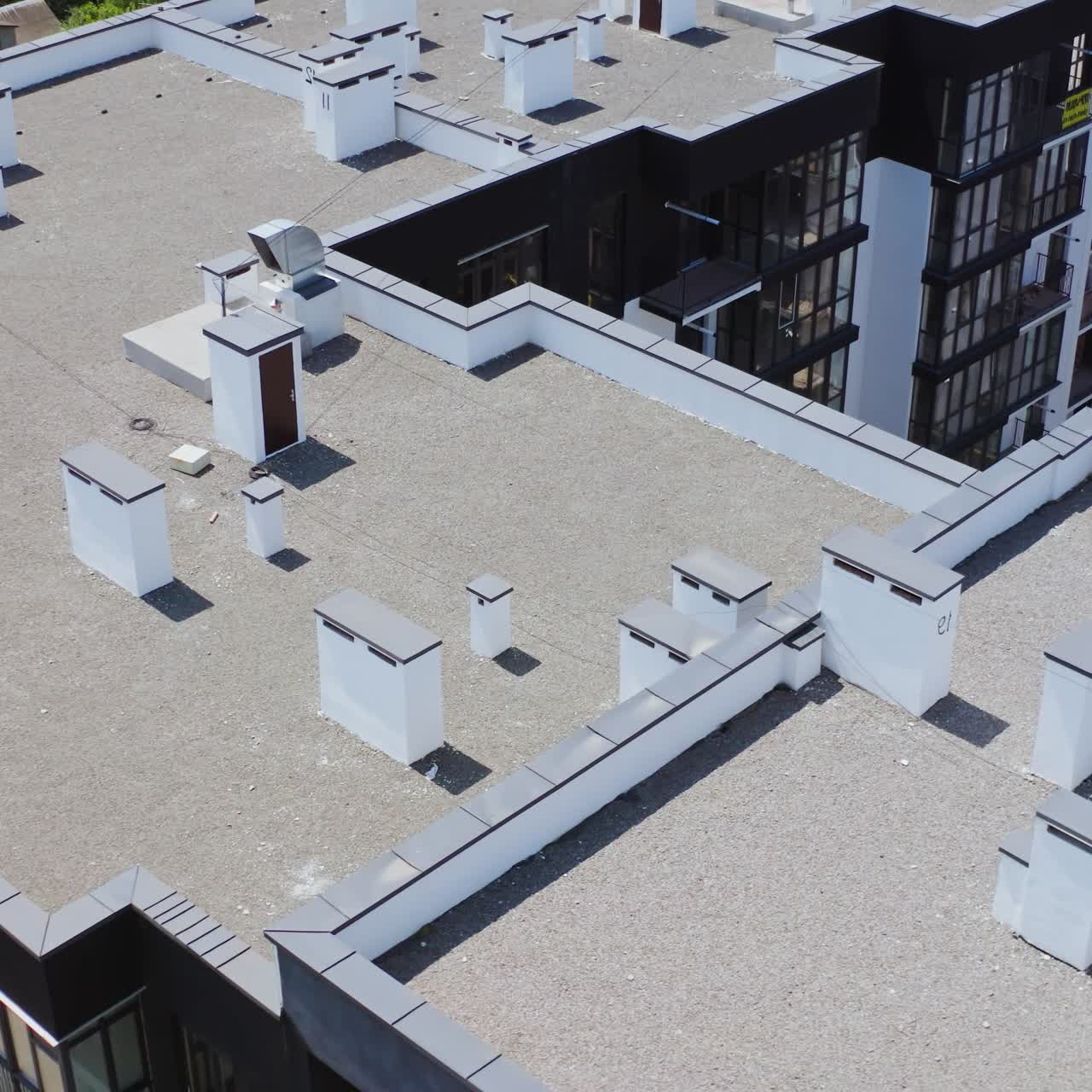 Roofs of a modern multi-storey complex. High apartment buildings in new district in the city. Top aerial view