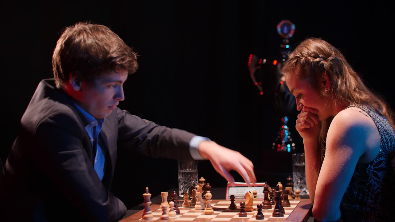 man captures black rook with white knight in low light chess match against woman