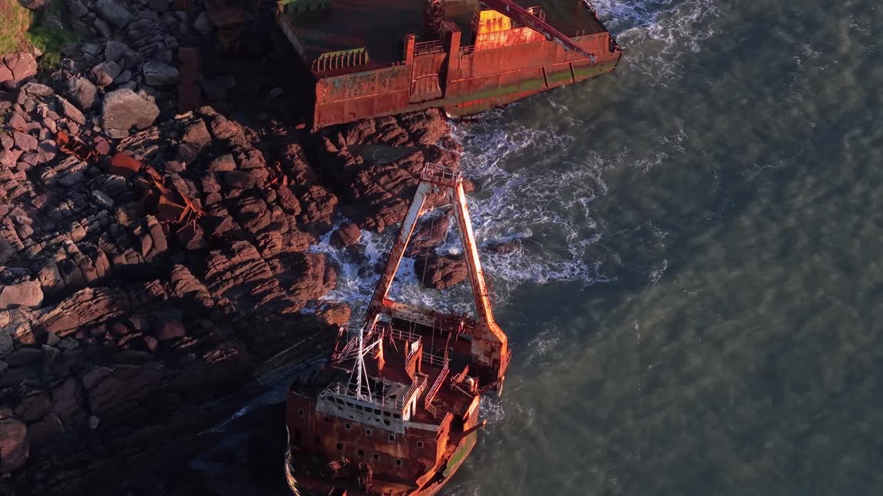 A shipwrecked fishing boat at golden hour near Ballycotton cliffs in Cork, Ireland