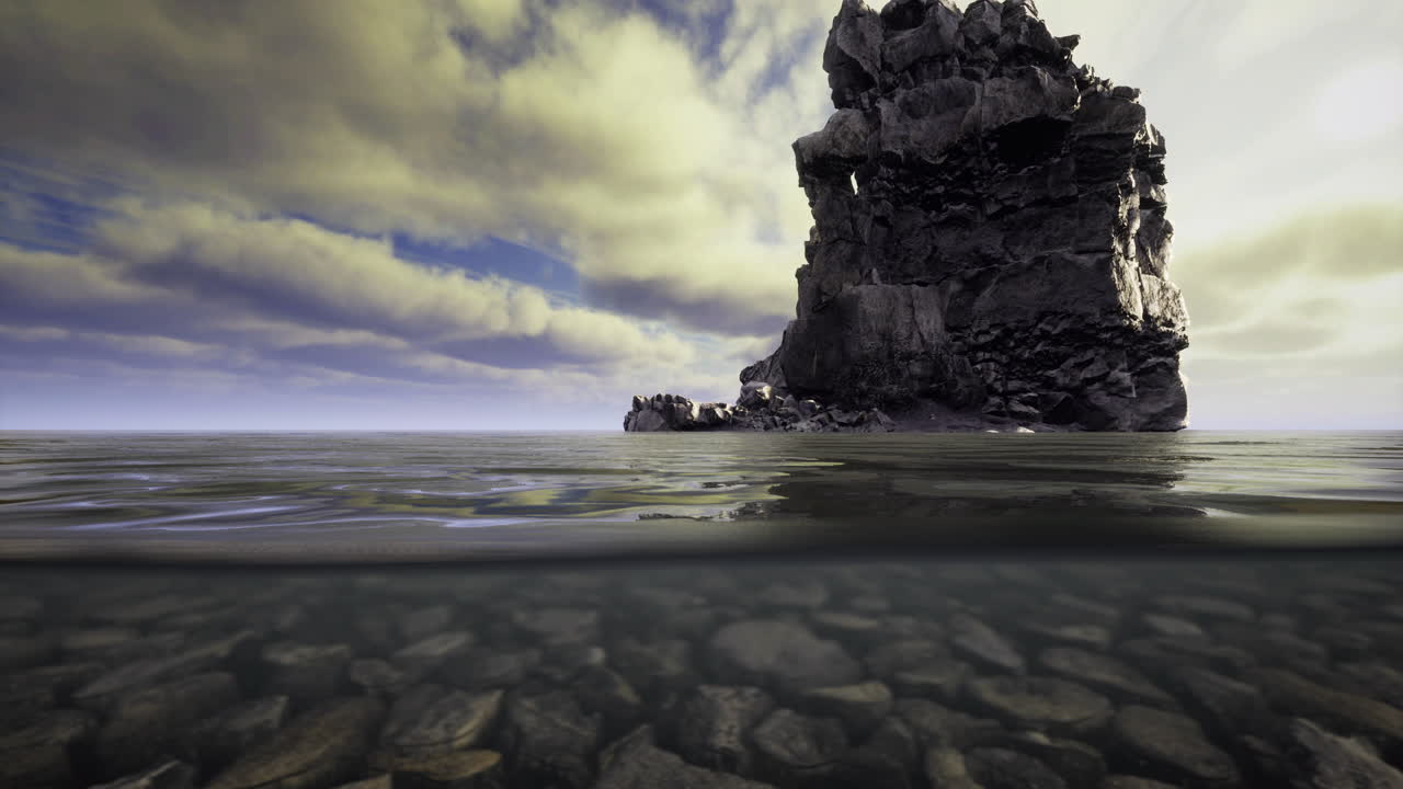 Rocky coastal formation stands tall above water during cloudy day