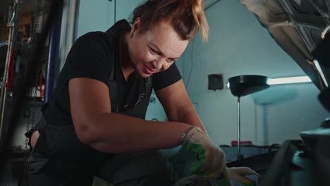 woman mechanic working on a car in a garage