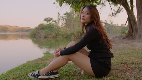 woman sitting by the lake