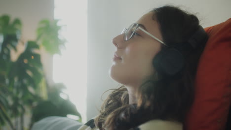 relaxed woman in headphones listening to music