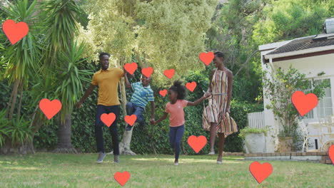 animation of hearts over happy african american family in garden