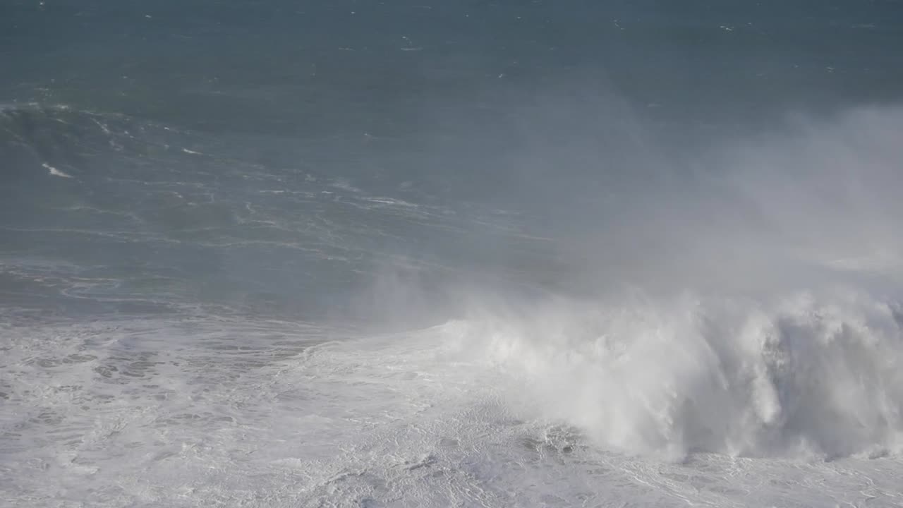 Massive ocean wave breaking in Nazare, Portugal, showing raw, powerful nature energy
