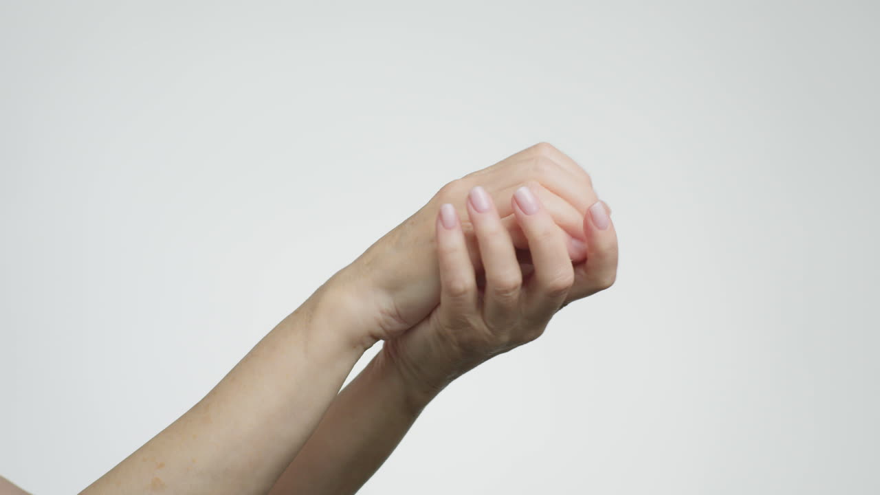 Close-up of hands rubbing together, demonstrating skin care or hygiene