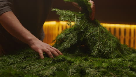 preparing a christmas fir tree arrangement