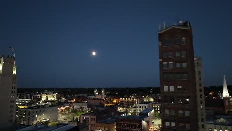 jackson, michigan downtown at night with drone video close up with moon moving right to left