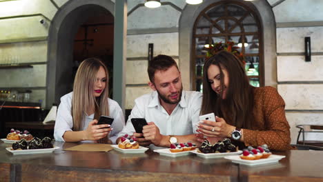 Cheerful-multiracial-friends-taking-selfie-in-pizzeria.