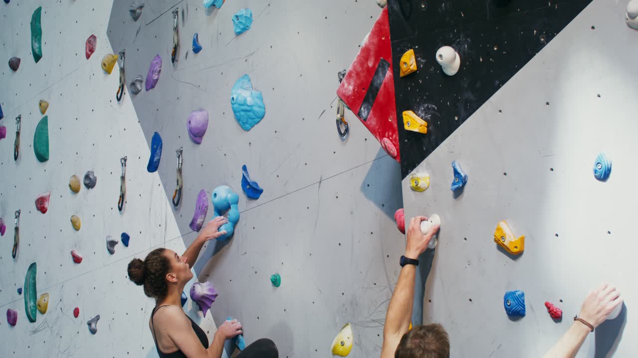 People rock climbing indoors