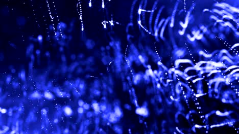la animación de bucle de renderizado 3d de las partículas de brillo forma líneas oscilantes como guirnalda oscilante como fondo festivo o fondo abstracto de partículas con profundidad de campo y bokeh como bucle vj. azul 20