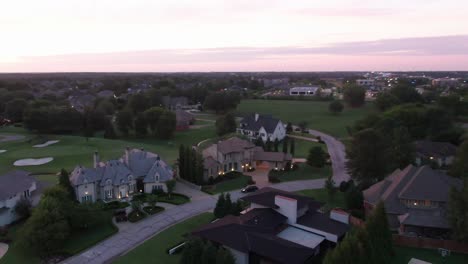 drone-shot-of-mansions-panning-up-to-a-clear-sky