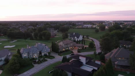 drone shot of mansions panning up to a clear sky