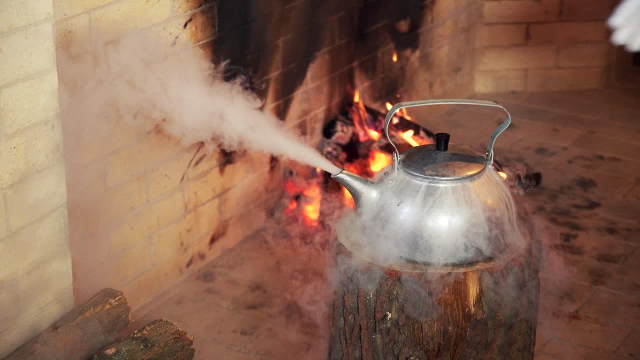 Santa Claus's Hand Reaching for a Steaming Kettle by a Fireplace